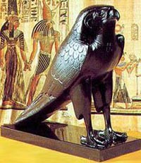 A Statue of Horus, If You Look Behind-You'll See A Wall Painting of Him Also